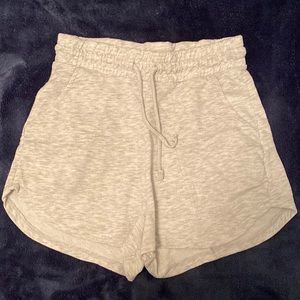 Gray, sweat pant material, shorts that hit a few inches above the knee.